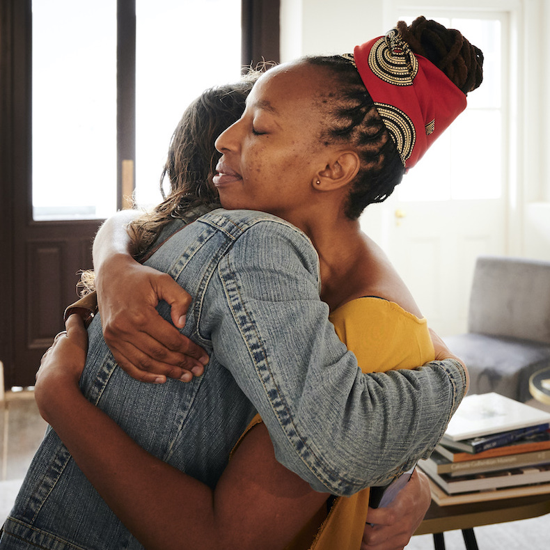 Two scholars hugging